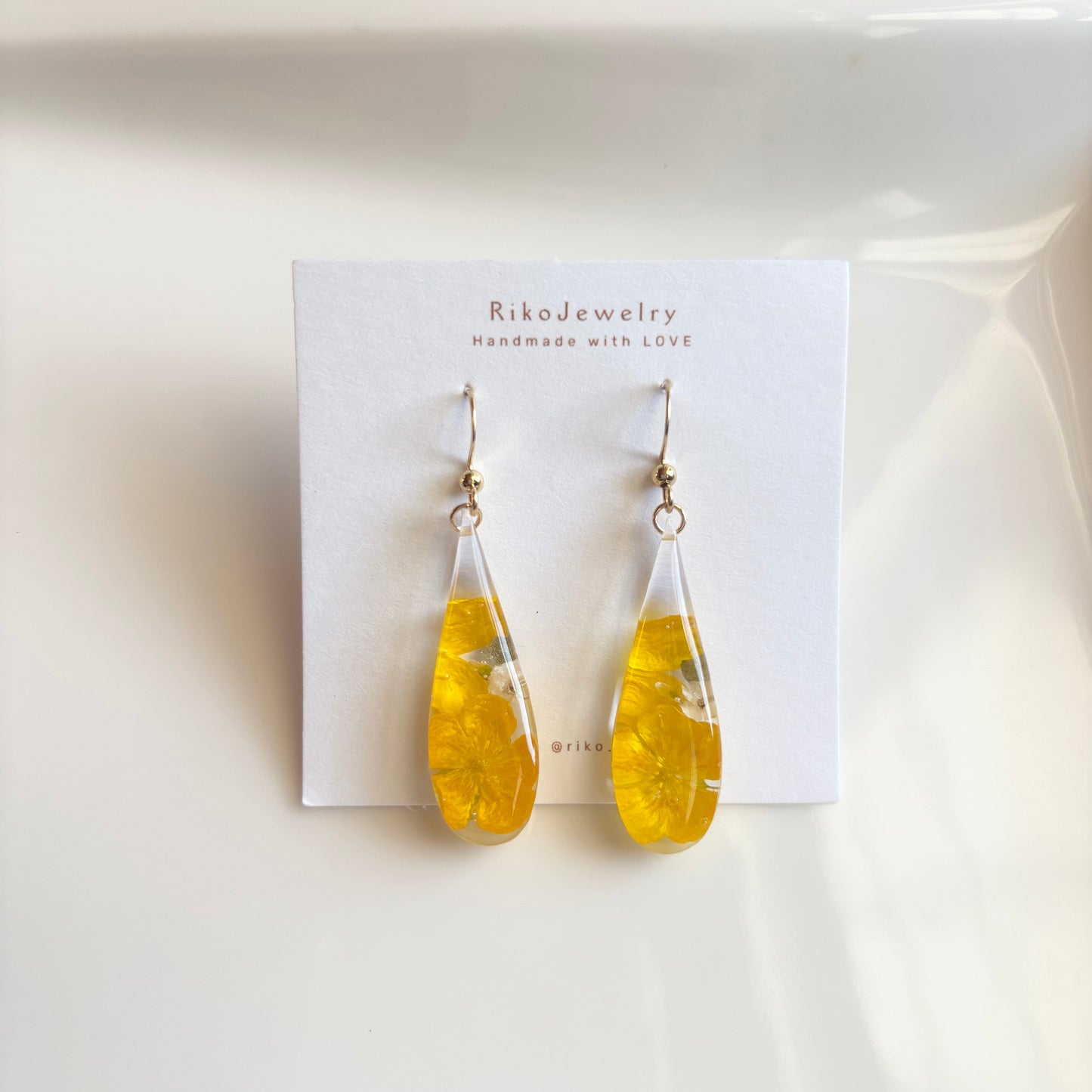 Bulbous buttercup flower and white alyssum flowers earrings
